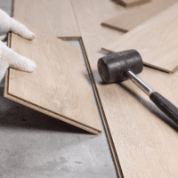 Home contractors working together on a house construction site, discussing plans and using tools.